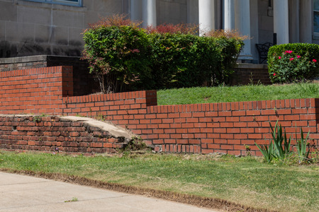 Old brick retaining wall in front of newer red brick retaining wall, horizontal aspectの写真素材