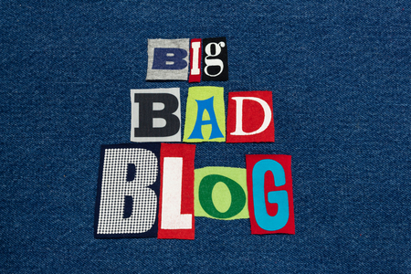 BIG BAD BLOG text word collage, colorful fabric on blue denim, blogger and blogging, horizontal aspectの写真素材