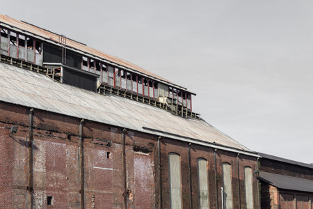 Walls and roof of an old industrial building warehouse, corrugated metal roof, horizontal aspect