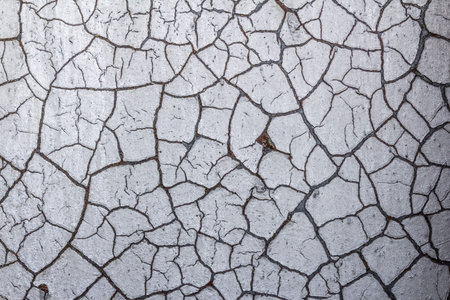 Cracked paint finish over rusted metal background, horizontal aspect