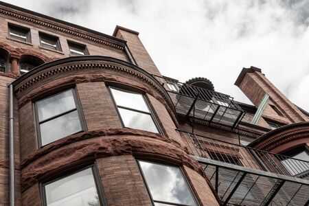 Rusticated stone and dentil moulding details on old brownstone apartment building exterior, horizontal aspectの写真素材