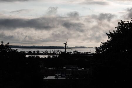 View of Dorchester Bay at dawn as seen from Ronan Park, windmill and rooftops, horizontal aspectの写真素材