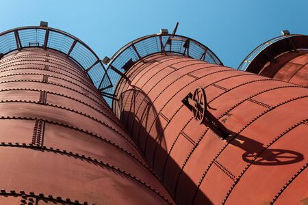 Sloss Furnaces National Historic Landmark, Birmingham Alabama USA, extreme angle looking up at furnaces, open circular catwalks, horizontal aspectの写真素材