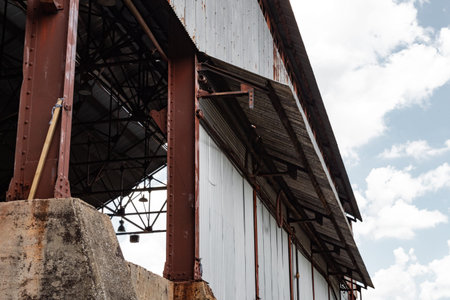 View inside an industrial warehouse, corrugated metal siding, concrete bases with metal i-beams,...