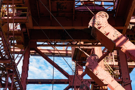 View through the exterior of an industrial facility to blue sky and clouds beyond, sunny day,...
