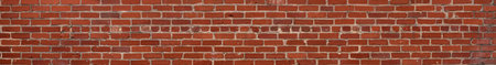 Extremely long thin panorama of red brick wall with irregular bricks in running bond pattern, horizontal aspectの写真素材