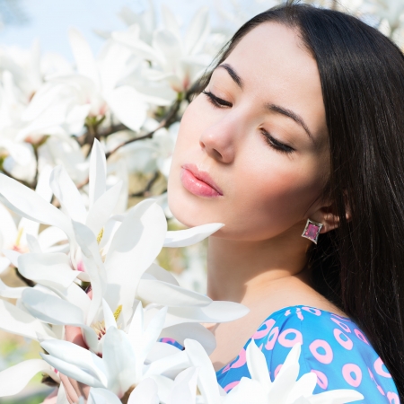 Woman in the flowers of magnoliaの写真素材