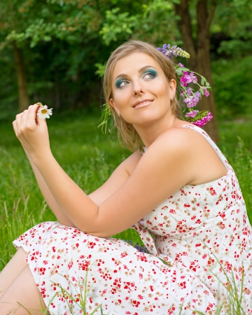 Woman on nature with flowers in her hairの写真素材