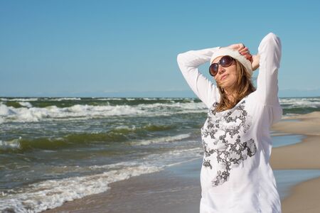 Woman walks by the seaの写真素材