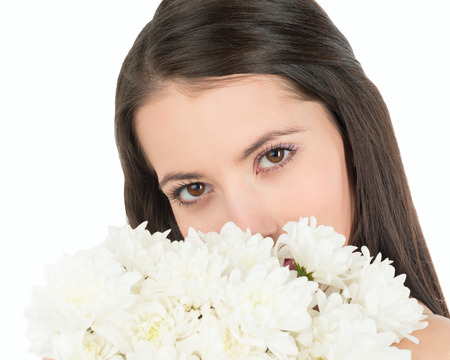    Woman looks out because of a bouquet of white chrysanthemums  の写真素材
