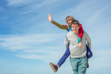 Happy man and woman on the sky backgroundの写真素材