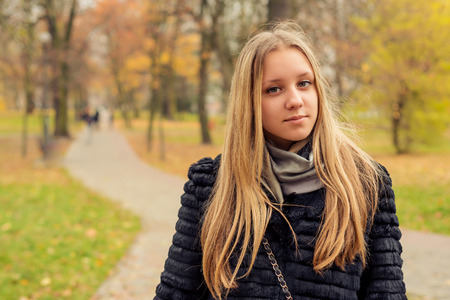 Portrait of teen girl in the autumn parkの写真素材