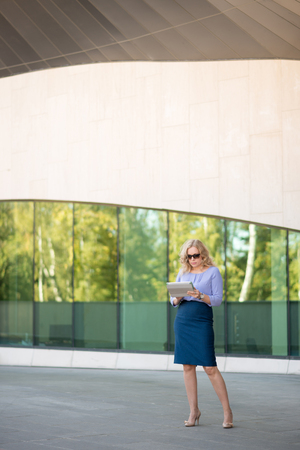 Woman blonde with digital tabletの写真素材