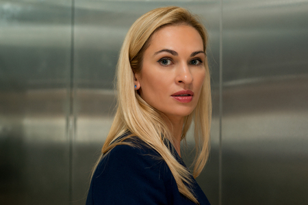 Woman blond in the elevatorの写真素材