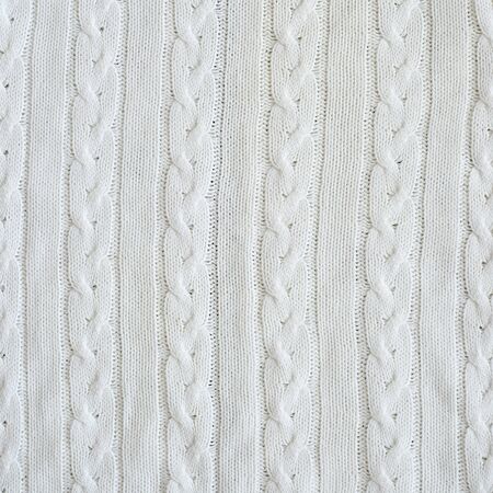 Background of white knitted jersey made of braidの写真素材