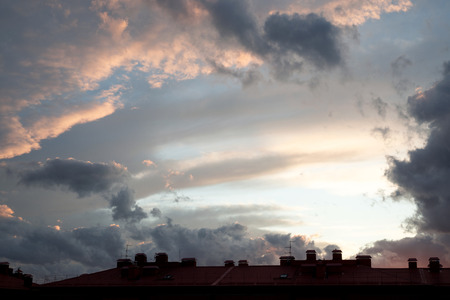 Thunderous sky over the roofs of housesの写真素材