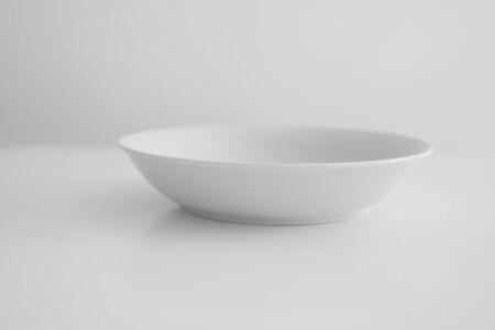 White plate stands on a white tableの写真素材