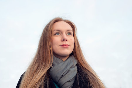 Portrait of a young woman with long hair with a proud look