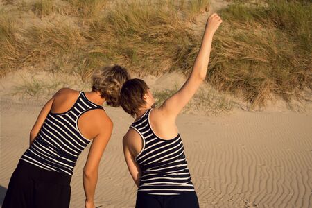 Two women dance a contact improvisation in natureの写真素材