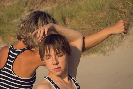 Two women dance a contact improvisation in natureの写真素材
