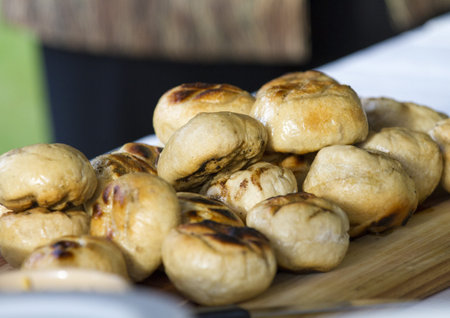 Warm bread rolls on a wooden board, just waiting to be eaten  