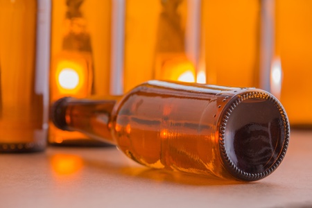 A brown beer bottle lying on it s side with more bottles in the background の写真素材