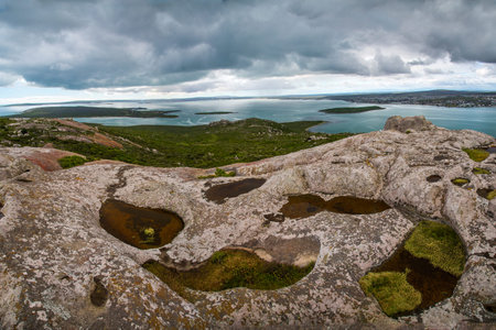 Rock pools by the ocean  Tropical, relaxing setting with calm waters and islands 