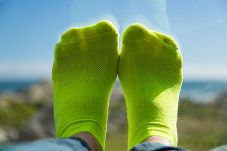 Lime green socks and her feet on the carの写真素材