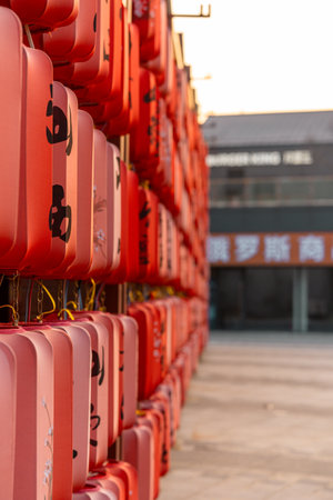 Rows of orange lanterns stacked in a row at a festivalの写真素材