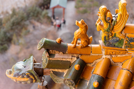 Prayer wheels on the roof of a Buddhist temple in Chinaの写真素材