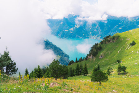 Beautiful mountain landscape with clear turquoise lake in the cloudsの写真素材