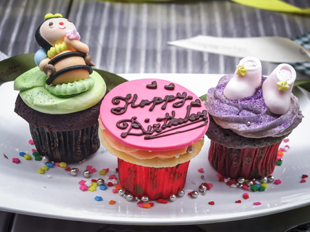 Decorated cup cake on a fancy plateの写真素材