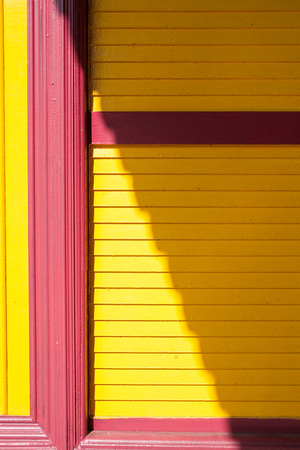 Yellow wooden wall with door frameの写真素材