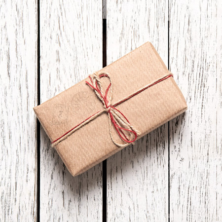 Vintage gift box on white wooden background. Closeup.