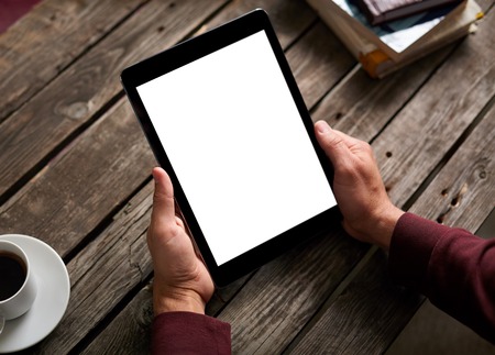 Man shows screen of digital tablet in his hands. Clipping path included.