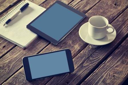 Smartphone and digital tablet devices on a desktop. Clipping paths included.の写真素材