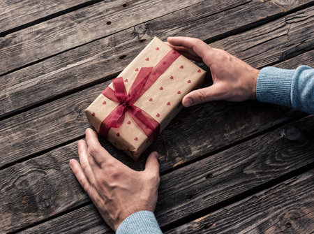 Gift box in man's hands. Top view.の写真素材