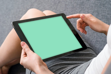 Woman takes a rest with tablet, on sofa.