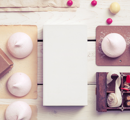 White box mockup between different sweets on the table and figuresの写真素材