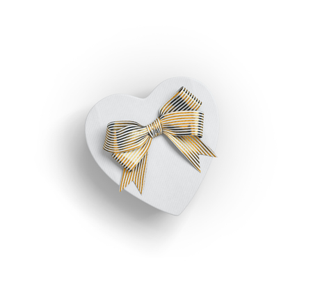 Heart shaped gift box with bow on whiteの写真素材