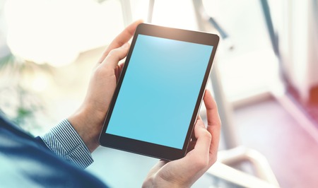 Mock up of a man holding digital tablet deviceの写真素材