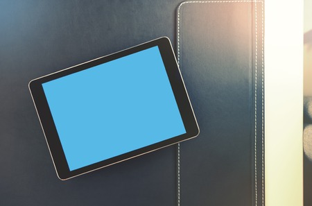 Mock up of black tablet computer on a desktop. Clipping path included.の写真素材
