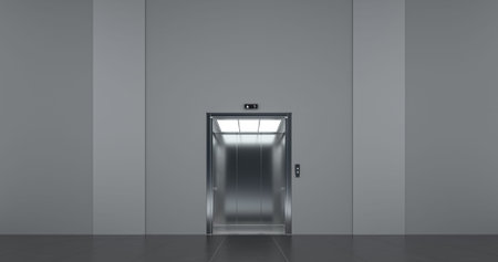 Elevator with open doors, at public space interior.