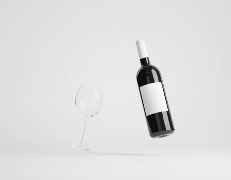 Wine bottle with wine glass over whiteの写真素材