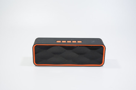 Black small speaker easy to carry can use wifi and sd card with an orange usage button for everyone in familyの写真素材