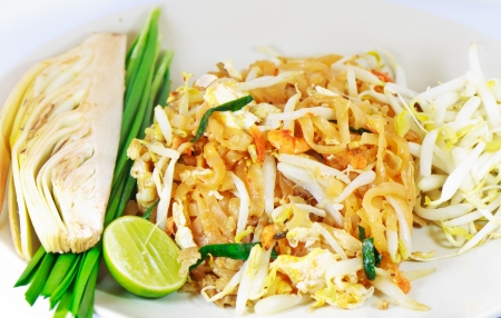 Thai-style stir-fry dishes  The noodles, egg, stove hood and vegetables combined with vegetables and lemon as a sideの写真素材
