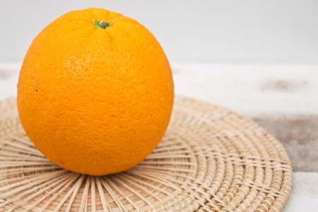 Ripe orange on Bamboo weavingの写真素材