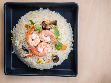 Fried rice with shrimps on woodの写真素材