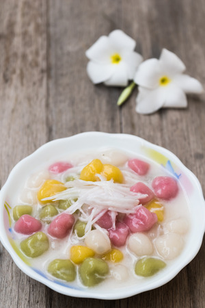 Thailand dessert Bua Loy and coconut milk  in cup on wooden tableの写真素材