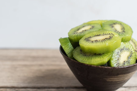 kiwi fresh fruit  in bowl on wood tableの写真素材